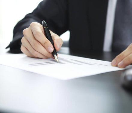 Man signing a Living Trust document