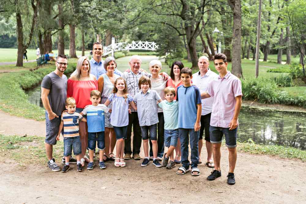 Multigenerational family gathered together from great grand parents to great grand sons posing for the picture in casual multicolored clothing